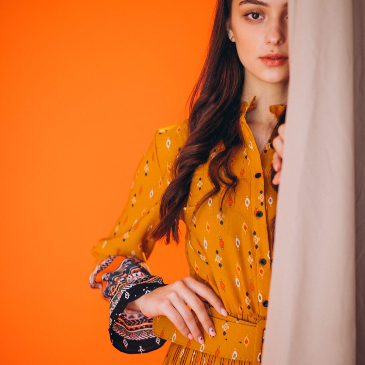 Young woman in a beautiful yellow dress in studio